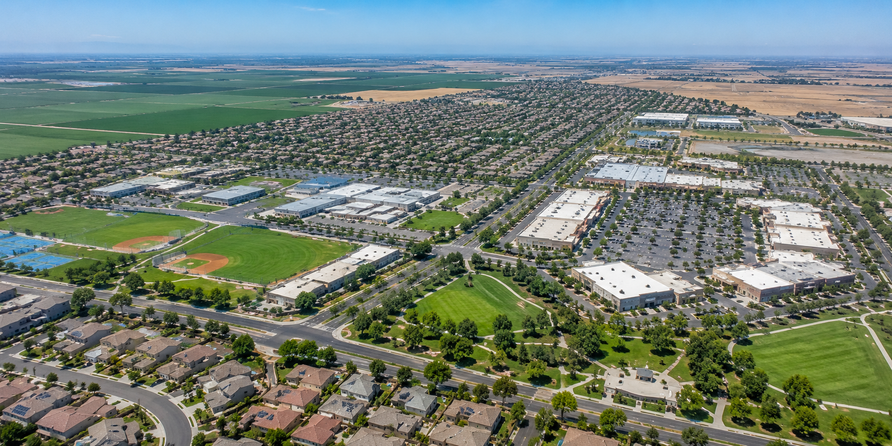 Aerial view of Manteca California showcasing residential neighborhoods, schools, shopping centers, and community amenities that make the city a desirable place to live
